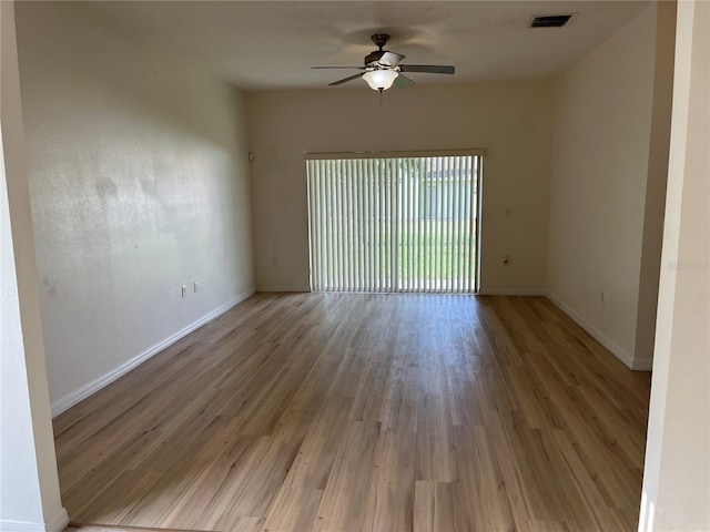 7714 Tanbier Dr, Orlando, FL 32818 - unfurnished room featuring wood finished floors and a ceiling fan