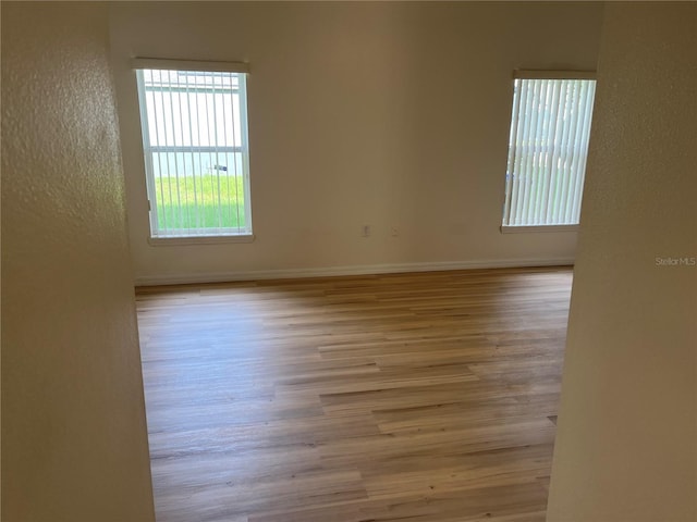 7714 Tanbier Dr, Orlando, FL 32818 - spare room with plenty of natural light, a textured wall, and wood finished floors