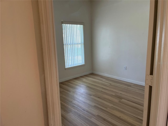 7714 Tanbier Dr, Orlando, FL 32818 - empty room featuring wood finished floors and baseboards