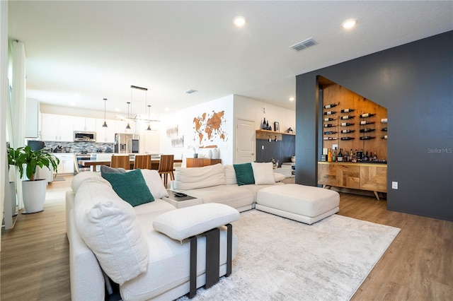 2813 Sanctuary Dr, Clermont, FL 34714 - living area with light wood-style flooring, recessed lighting, and a dry bar