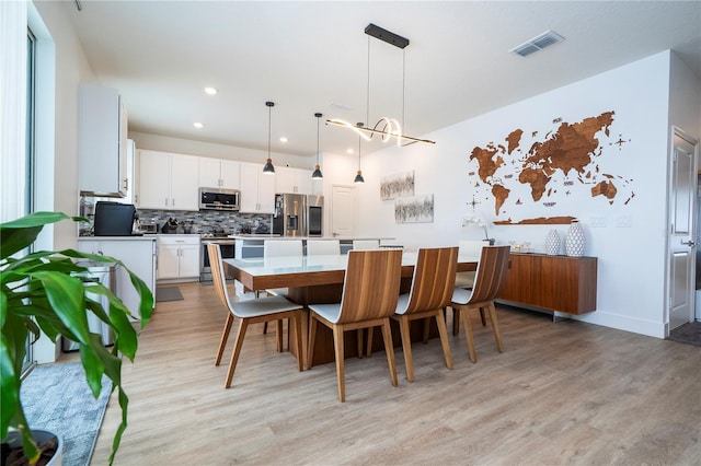 2813 Sanctuary Dr, Clermont, FL 34714 - dining area with light wood finished floors, recessed lighting, and a chandelier