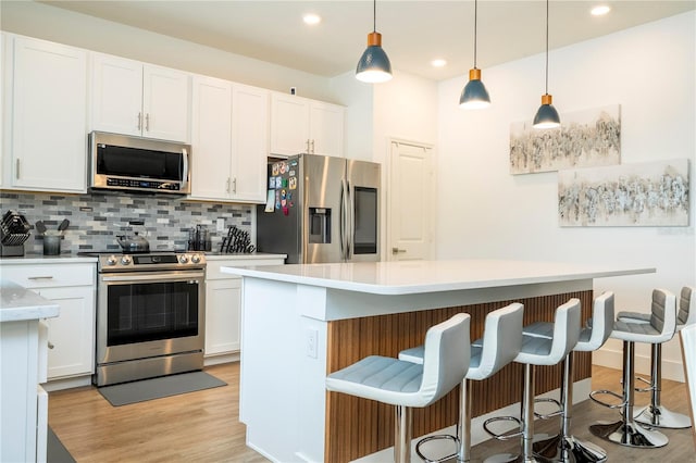 2813 Sanctuary Dr, Clermont, FL 34714 - kitchen featuring stainless steel appliances, light wood finished floors, backsplash, light countertops, and recessed lighting
