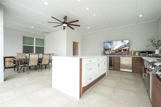 2813 Sanctuary Dr, Clermont, FL 34714 - kitchen with refrigerator, beverage cooler, a ceiling fan, white cabinets, and recessed lighting