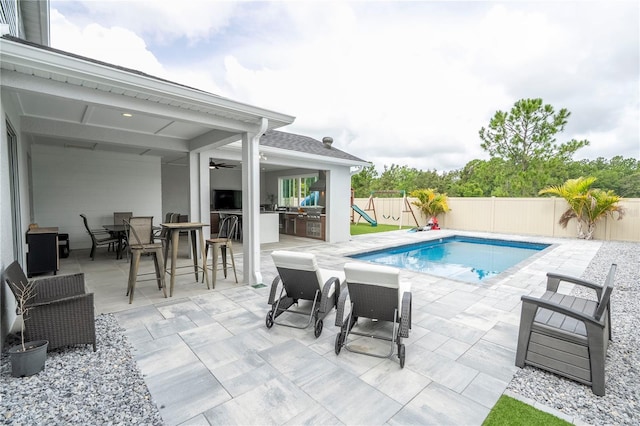 2813 Sanctuary Dr, Clermont, FL 34714 - view of swimming pool with a fenced backyard, a patio, outdoor dining space, a ceiling fan, and a playground