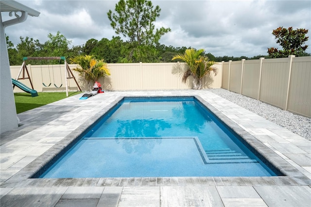 2813 Sanctuary Dr, Clermont, FL 34714 - view of swimming pool with a patio, a fenced backyard, and a playground