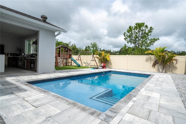 2813 Sanctuary Dr, Clermont, FL 34714 - view of pool with a patio, a fenced backyard, a playground, and a grill