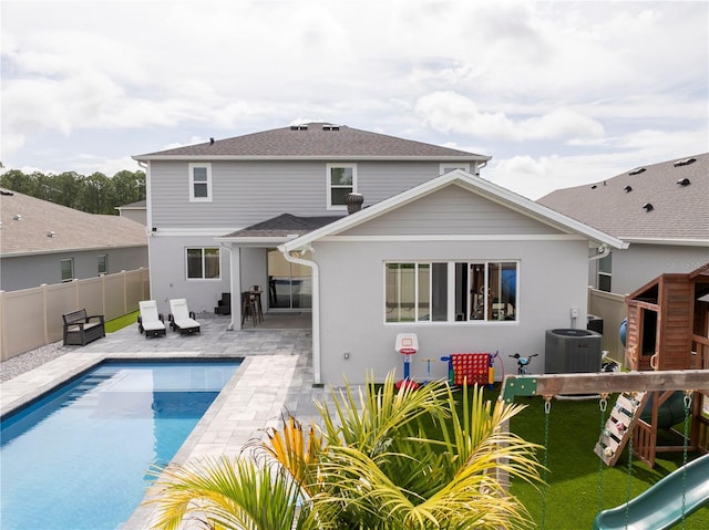 2813 Sanctuary Dr, Clermont, FL 34714 - back of property with a patio area, a playground, and stucco siding