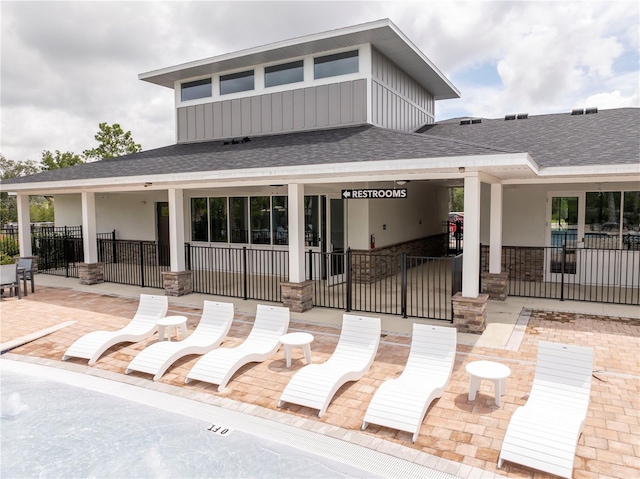 2813 Sanctuary Dr, Clermont, FL 34714 - view of front of home with roof with shingles, stone siding, a patio, and stucco siding