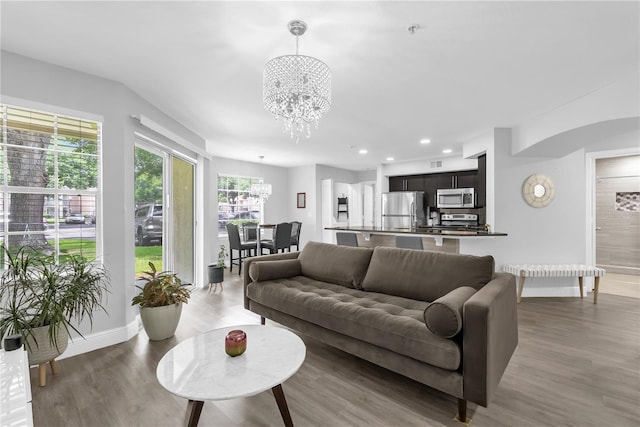 7350 Westpointe Blvd Unit 215, Orlando, FL 32835 - living area featuring a chandelier, wood finished floors, and recessed lighting