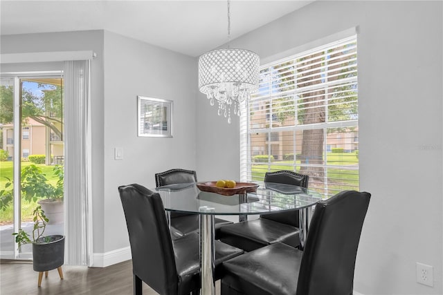 7350 Westpointe Blvd Unit 215, Orlando, FL 32835 - dining space featuring a chandelier and wood finished floors