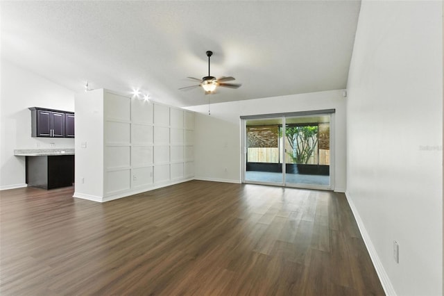 669 Whitetail Loop, Apopka, FL 32703 - unfurnished living room with dark wood-type flooring, ceiling fan, and vaulted ceiling