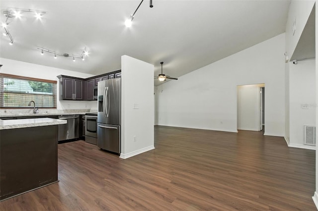 669 Whitetail Loop, Apopka, FL 32703 - kitchen featuring appliances with stainless steel finishes, open floor plan, vaulted ceiling, a ceiling fan, and light stone countertops