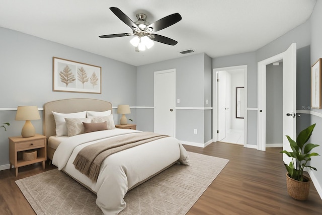 669 Whitetail Loop, Apopka, FL 32703 - bedroom with dark wood-style flooring, a ceiling fan, and connected bathroom
