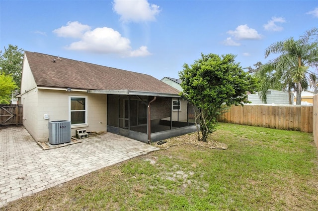 669 Whitetail Loop, Apopka, FL 32703 - back of house with roof with shingles, a sunroom, a fenced backyard, a patio area, and concrete block siding