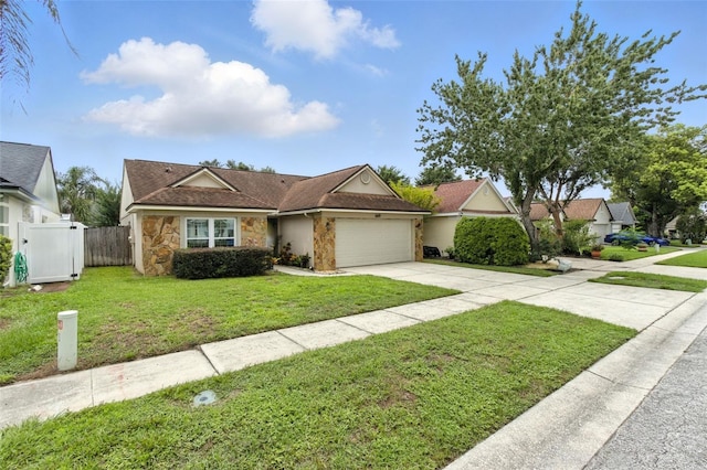 669 Whitetail Loop, Apopka, FL 32703 - view of front facade with stone siding, an attached garage, and concrete driveway