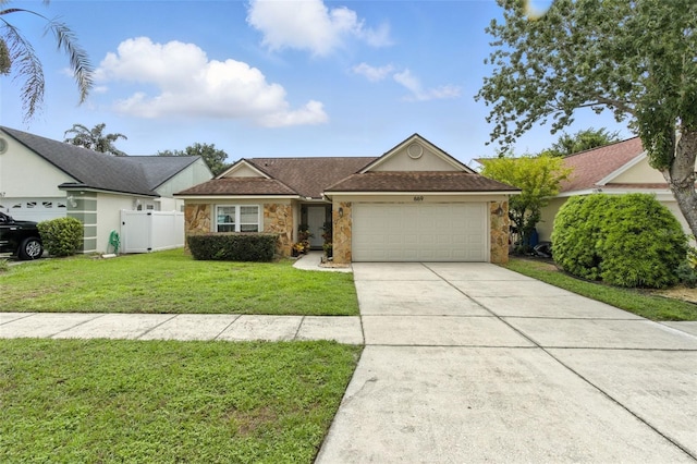 669 Whitetail Loop, Apopka, FL 32703 - ranch-style house with stone siding, a garage, and driveway