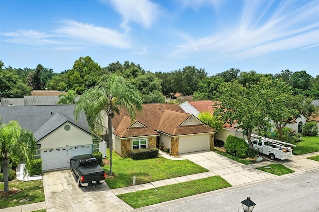 669 Whitetail Loop, Apopka, FL 32703 - view of front of house with driveway, a garage, and stone siding