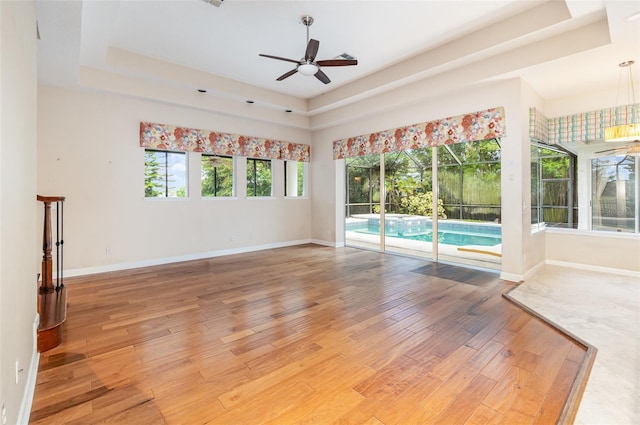 2317 Warren Woods Dr, Orlando, FL 32835 - spare room featuring a raised ceiling, a ceiling fan, and light wood finished floors