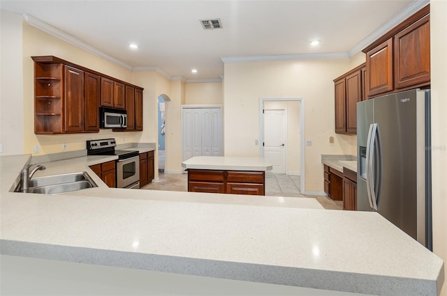 2317 Warren Woods Dr, Orlando, FL 32835 - kitchen featuring stainless steel appliances, open shelves, arched walkways, crown molding, and light countertops