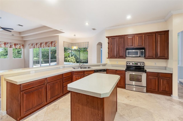 2317 Warren Woods Dr, Orlando, FL 32835 - kitchen featuring appliances with stainless steel finishes, a peninsula, arched walkways, light countertops, and a kitchen island