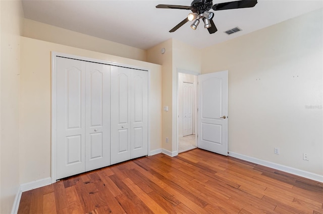 2317 Warren Woods Dr, Orlando, FL 32835 - unfurnished bedroom with light wood-style flooring, a closet, and ceiling fan