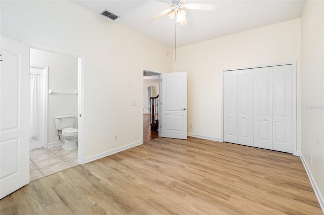 2317 Warren Woods Dr, Orlando, FL 32835 - unfurnished bedroom featuring light wood-style floors, ensuite bath, a closet, and ceiling fan