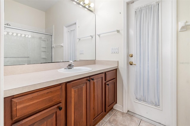 2317 Warren Woods Dr, Orlando, FL 32835 - bathroom featuring tile patterned floors, vanity, and an enclosed shower