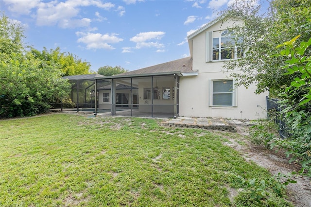 2317 Warren Woods Dr, Orlando, FL 32835 - back of house with a lawn, stucco siding, glass enclosure, and a patio