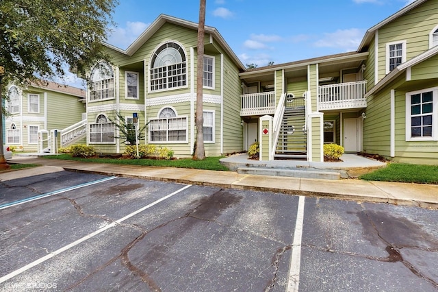 3151 Britannia Blvd Unit A, Kissimmee, FL 34747 - view of property with stairway and uncovered parking