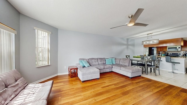 3151 Britannia Blvd Unit A, Kissimmee, FL 34747 - living area featuring a ceiling fan and light wood finished floors