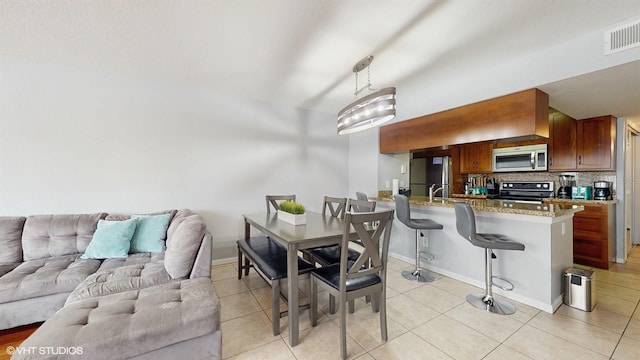 3151 Britannia Blvd Unit A, Kissimmee, FL 34747 - dining room with light tile patterned floors