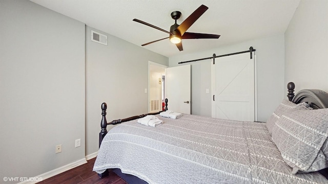 3151 Britannia Blvd Unit A, Kissimmee, FL 34747 - bedroom featuring a barn door, dark wood finished floors, and ceiling fan