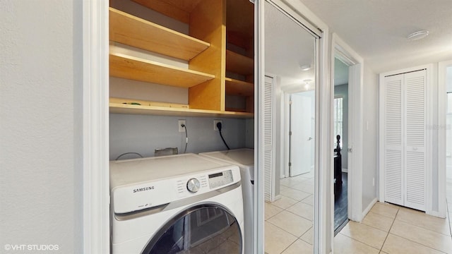 3151 Britannia Blvd Unit A, Kissimmee, FL 34747 - washroom with washer / clothes dryer and light tile patterned floors