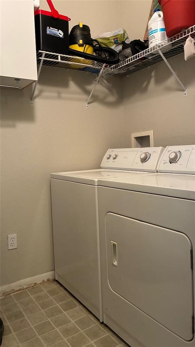 washroom featuring independent washer and dryer and baseboards