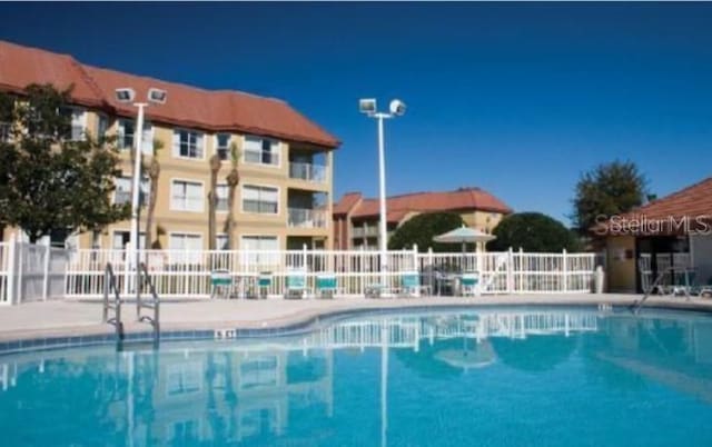 6336 Parc Corniche Dr, Orlando, FL 32821 - community pool with a patio area