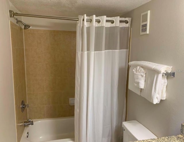 6336 Parc Corniche Dr, Orlando, FL 32821 - bathroom featuring shower / bath combination with curtain and a textured ceiling