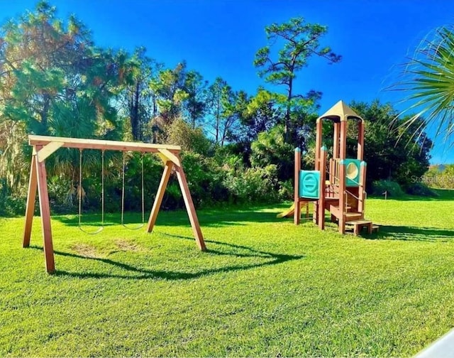 6336 Parc Corniche Dr, Orlando, FL 32821 - view of play area with a lawn