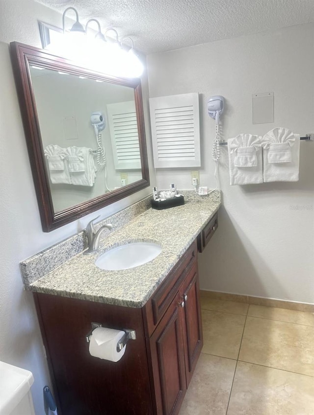6336 Parc Corniche Dr, Orlando, FL 32821 - bathroom featuring vanity, tile patterned flooring, and a textured ceiling