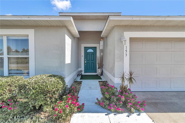 153 Juniper Run, Ocala, FL 34480 - entrance to property featuring stucco siding and an attached garage