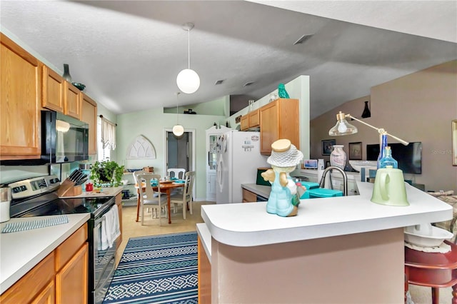 153 Juniper Run, Ocala, FL 34480 - kitchen with stainless steel electric stove, vaulted ceiling, black microwave, freestanding refrigerator, and light countertops
