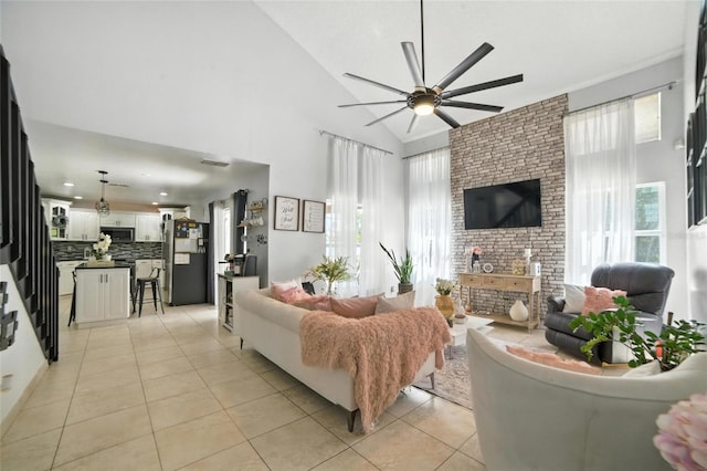 12419 Sion Ct, Orlando, FL 32824 - living area featuring light tile patterned flooring, ceiling fan, high vaulted ceiling, and a fireplace