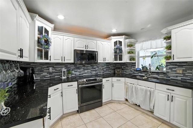 12419 Sion Ct, Orlando, FL 32824 - kitchen featuring appliances with stainless steel finishes, open shelves, white cabinetry, light tile patterned flooring, and recessed lighting