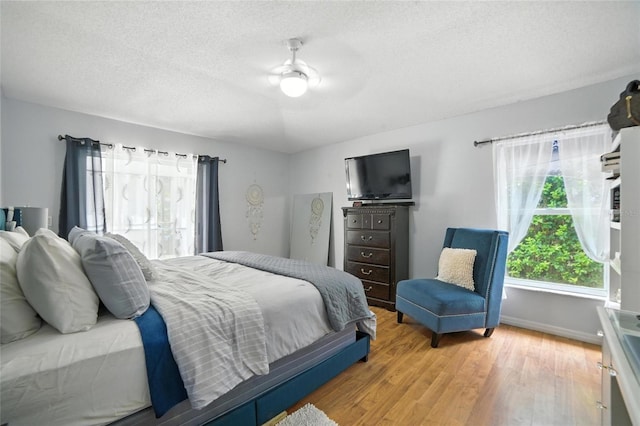 12419 Sion Ct, Orlando, FL 32824 - bedroom with wood finished floors, a textured ceiling, and a ceiling fan
