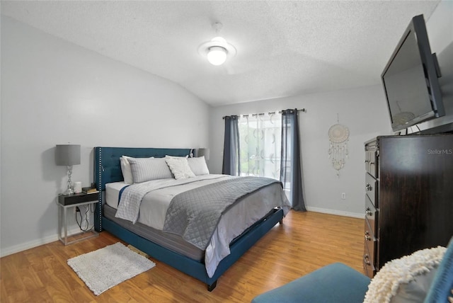 12419 Sion Ct, Orlando, FL 32824 - bedroom with a textured ceiling, light wood-style floors, and lofted ceiling