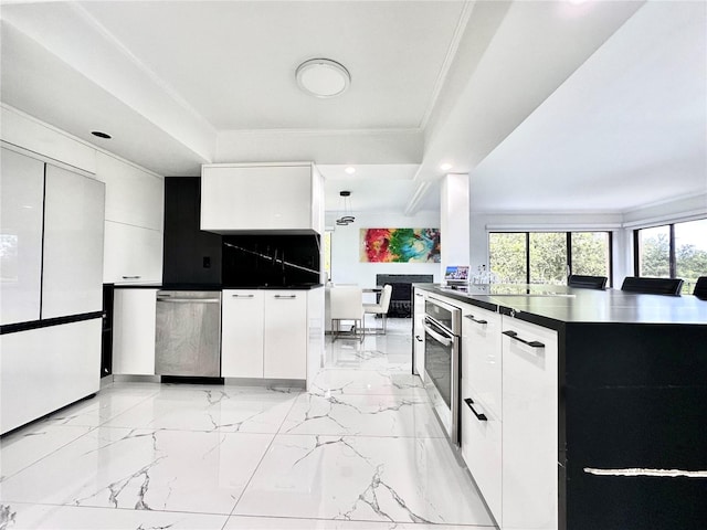 6258 Masters Blvd Unit C204, Orlando, FL 32819 - kitchen featuring appliances with stainless steel finishes, dark countertops, modern cabinets, crown molding, and recessed lighting
