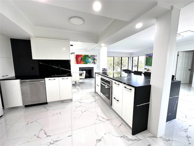 6258 Masters Blvd Unit C204, Orlando, FL 32819 - kitchen with stainless steel appliances, modern cabinets, dark countertops, ornamental molding, and white cabinets