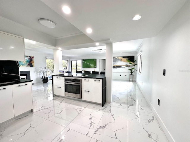 6258 Masters Blvd Unit C204, Orlando, FL 32819 - kitchen featuring stainless steel oven, recessed lighting, dark countertops, white cabinets, and ornamental molding
