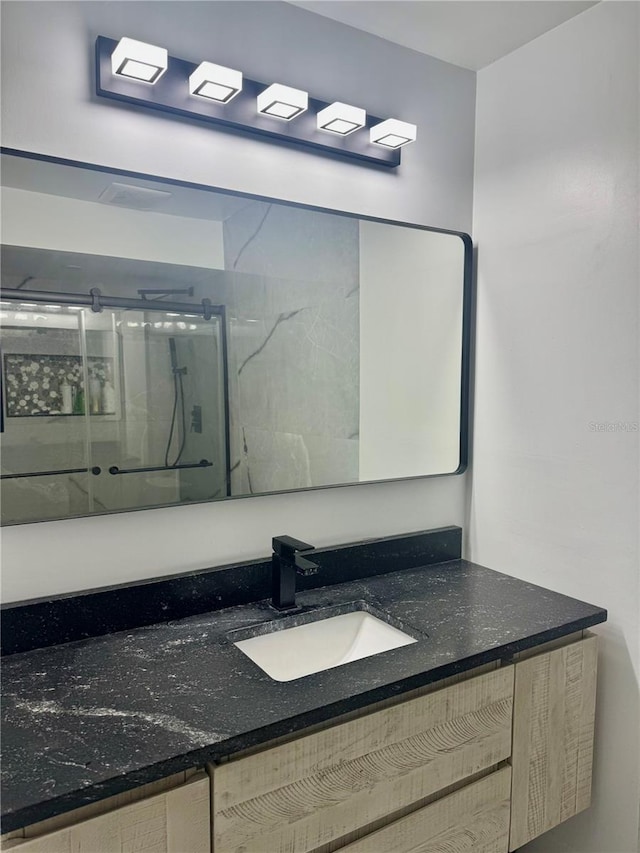 6258 Masters Blvd Unit C204, Orlando, FL 32819 - bathroom featuring a marble finish shower and vanity