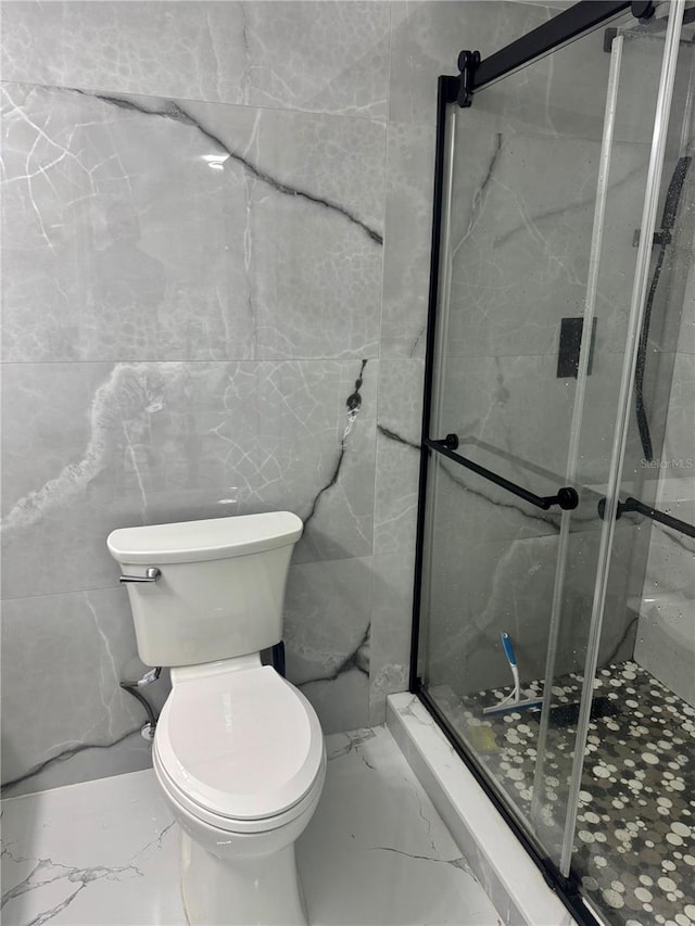 6258 Masters Blvd Unit C204, Orlando, FL 32819 - full bathroom featuring marble tiled flooring, a marble finish shower, and tile walls