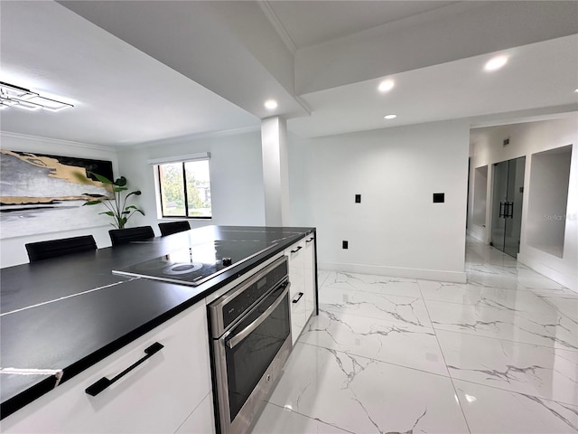 6258 Masters Blvd Unit C204, Orlando, FL 32819 - kitchen featuring oven, black electric cooktop, crown molding, recessed lighting, and dark countertops